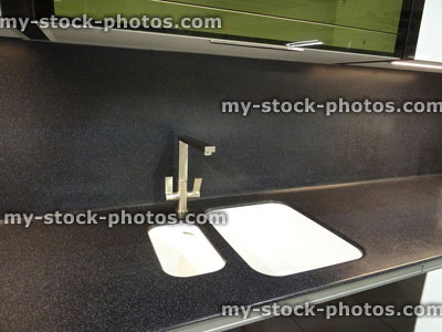 Stock image of monochrome, black / white double ceramic kitchen sink, stainless steel mixer tap, worktop
