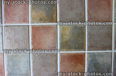 Stock image of rustic square kitchen tiles in brown, grey, orange