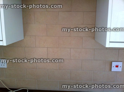 Stock image of beige kitchen tiles, brick effect light brown stone / ceramic tiles