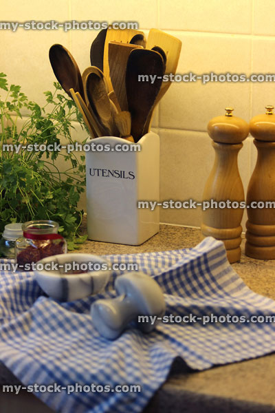 Stock image of wooden kitchen utensils, herbs, salt pepper pots, pestle mortar