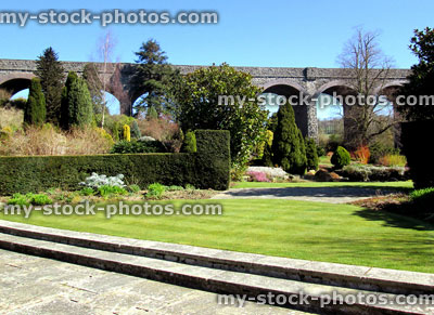 Stock image of manicured lawn stripes, green grass, garden steps, bridge