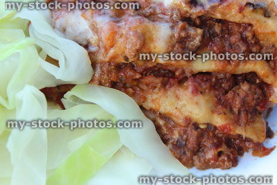 Stock image of homemade lasagna / lasagne layers / sliced, served boiled cabbage