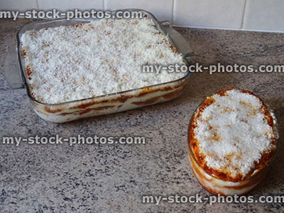 Stock image of homemade lasagne / glass lasagna dish, grated parmesan cheese, vegetarian / meat