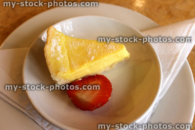 Stock image of small slice of lemon tart / torte, with strawberry