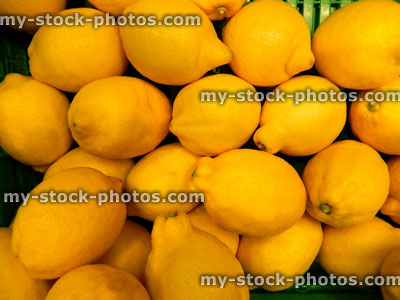 Stock image of fresh, ripe, unwaxed yellow lemons at supermarket, fruit shop