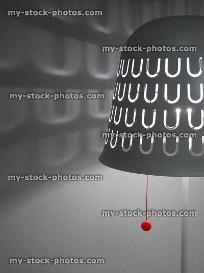 Stock image of white metal floor lamp shade / pull cord switch, shadow pattern