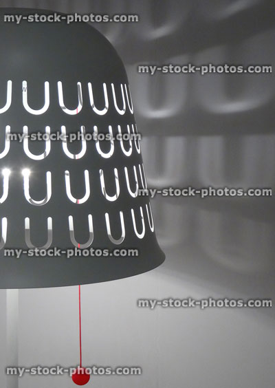 Stock image of metal light / lamp shade with perforated cut outs, pull switch cord