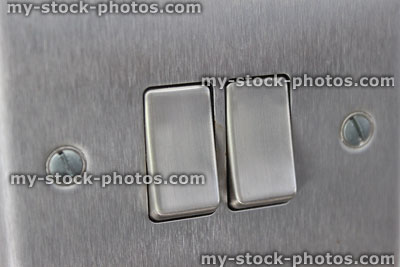 Stock image of stylish, contemporary double stainless steel light switch, square