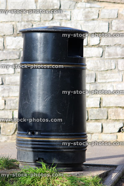 Stock image of single outdoor litter bin, made from black metal 