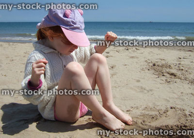 Stock image of girl with sand in her toes