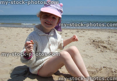 Stock image of little playing in sand on the beach