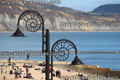 Stock image of seaside cliffs, ammonite street lamps at Lyme Regis beach
