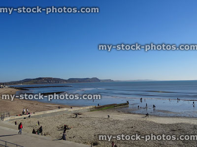 Stock image of sandy beach and holidaymakers in Lyme Regis, Dorset