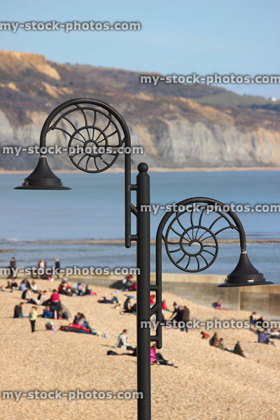 Stock image of sandy beach at Lyme Regis, ammonite fossil street lamps