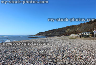 Stock image of Lyme Regis beach huts, cliffs and summer seafront