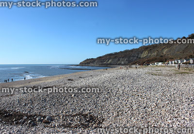Stock image of beach huts at cliffs on Lyme Regis seafront