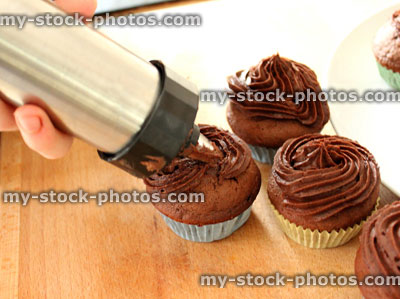 Stock image of Easter Cakes being frosted with an icing nozzle
