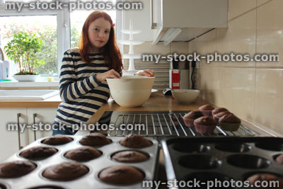Stock image of girl in a kitchen making cake mix