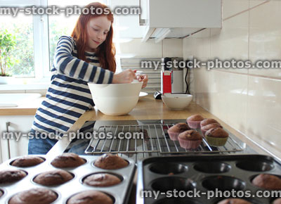Stock image of girl in a kitchen making frosting