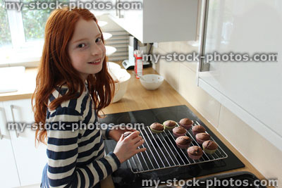 Stock image of girl baking in a contemporary white kitchen