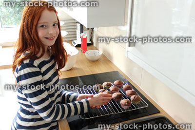 Stock image of girl baking in a contemporary white kitchen