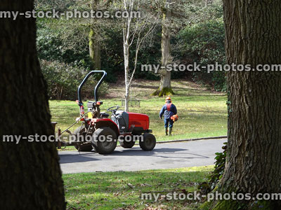 Stock image of man gardening with tractor, petrol lawn strimmer, safety helmet
