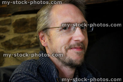 Stock image of ageing middle aged man with grey hair, wrinkles and rimless glasses