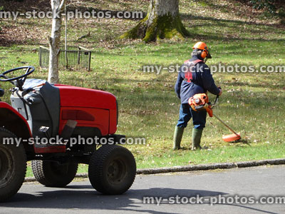 Stock image of landscape gardener working outside, strimming grass with lawn strimmer