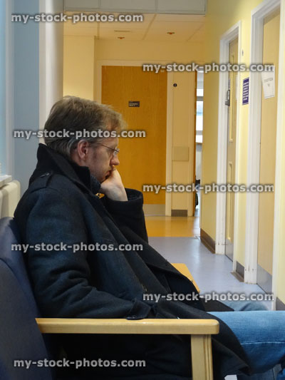 Stock image of man / patient sitting in hospital waiting room, doctor's appointment