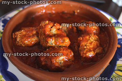 Stock image of meatballs in earthenware dish, part of Tapas meal at Spanish restaurant