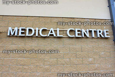 Stock image of modern silver Medical Centre sign, pale brick wall