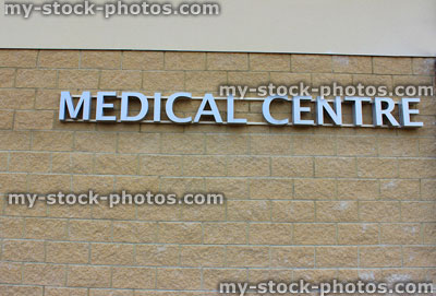 Stock image of modern silver Medical Centre sign, pale brick wall