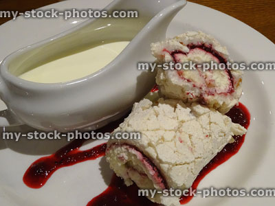 Stock image of rolled raspberry meringue roulade dessert pudding with cream