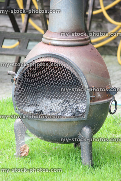 Stock image of rusty iron chiminea outdoor fireplace / woodburner barbecue, chimney