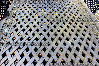 Stock image of weathered metal garden table top , overlapping gridwork