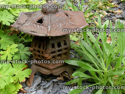 Stock image of rusty metal / cast iron lantern in Japanese garden