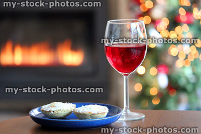 Stock image of red mulled wine glass, homemade Christmas mince pies / gas fire