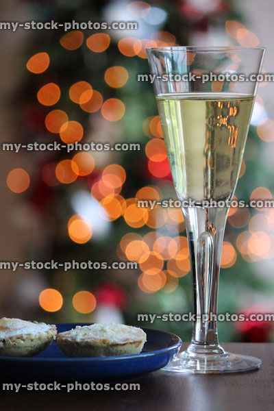Stock image of mince pies, wine glass and fairylights at Christmas