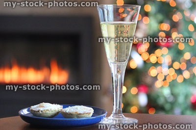 Stock image of mince pies with glass of white wine, Christmas tree fairylights