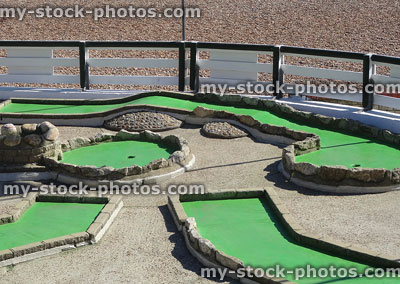 Stock image of seaside mini golf course, next to pebble beach