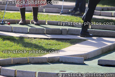 Stock image of people playing crazy golf course / mini golf putting greens