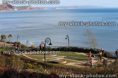 Stock image of families playing on miniature golf course by sea