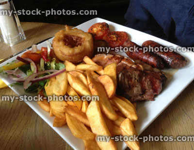 Stock image of traditional mixed grill with steak and chips