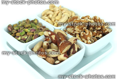 Stock image of dishes of mixed nuts, cashews, walnuts, pistachios and brazils