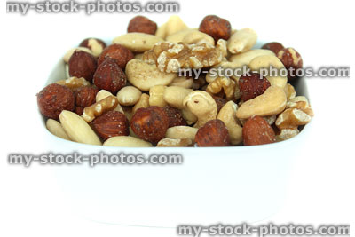 Stock image of mixed nuts in dish, almonds, cashews, hazelnuts, walnuts, high fibre