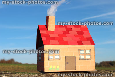 Stock image of homemade model cardboard dolls house with red roof, chimney