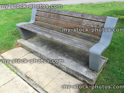 Stock image of modern curved wooden and metal bench in lawn
