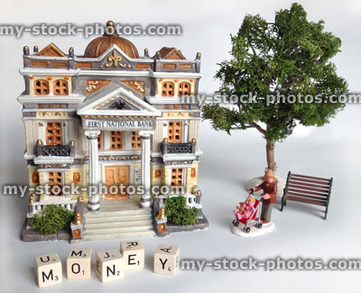 Stock image of model bank with dice spelling 'money'