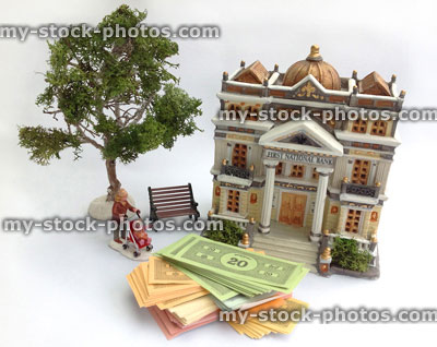 Stock image of model bank with paper Monopoly money (cash)