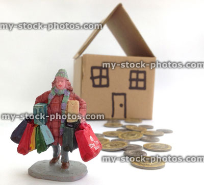 Stock image of woman with shopping bags, coins and dollshouse
